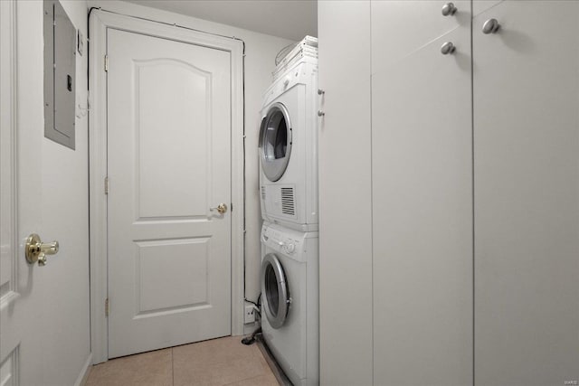 washroom with laundry area, stacked washer / dryer, and light tile patterned flooring