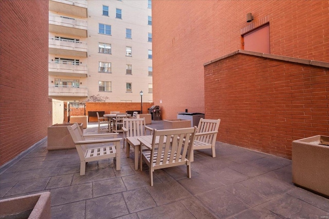 view of patio / terrace featuring outdoor dining space and grilling area