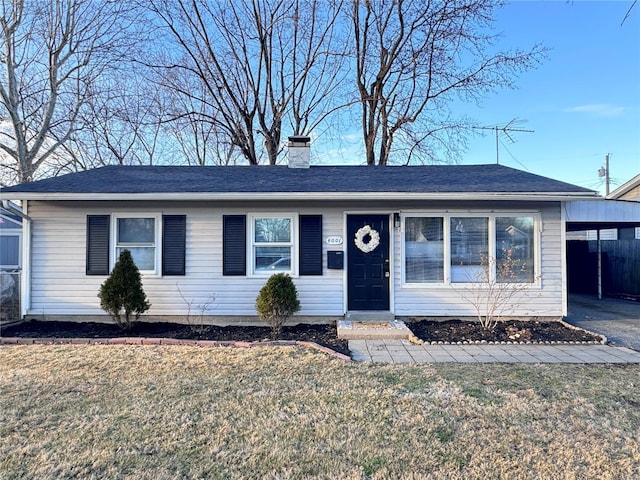 single story home featuring an attached carport, driveway, a chimney, and a front lawn