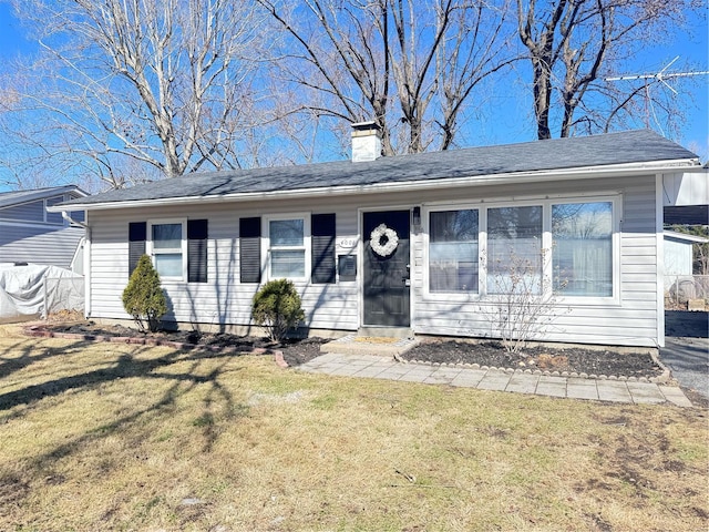 single story home with a chimney and a front lawn