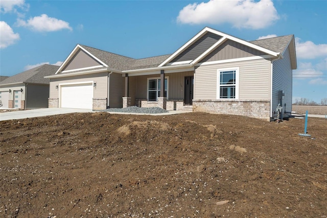 single story home with a garage, stone siding, board and batten siding, and concrete driveway