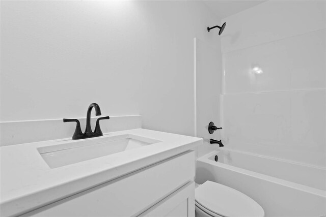 bathroom with  shower combination, vanity, and toilet