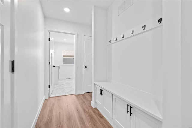 mudroom with light wood-type flooring, visible vents, baseboards, and recessed lighting