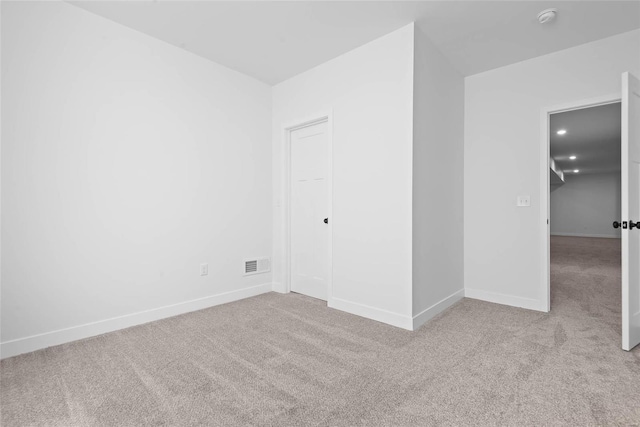 unfurnished bedroom with recessed lighting, carpet, visible vents, and baseboards