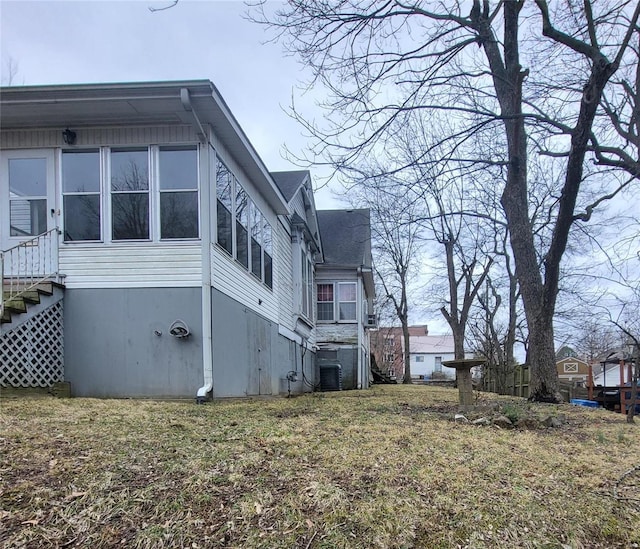 view of side of home featuring a yard