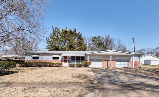 ranch-style house with brick siding, driveway, and an attached garage