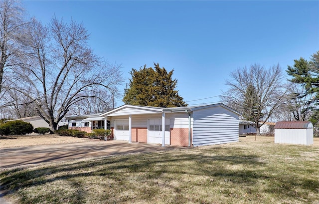 garage featuring a storage unit and driveway