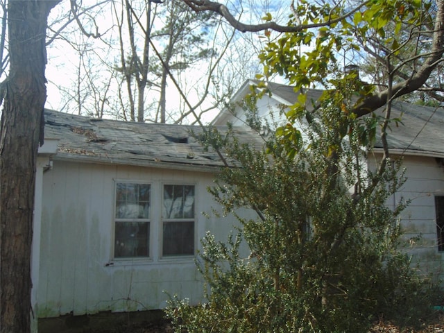 view of home's exterior featuring roof with shingles