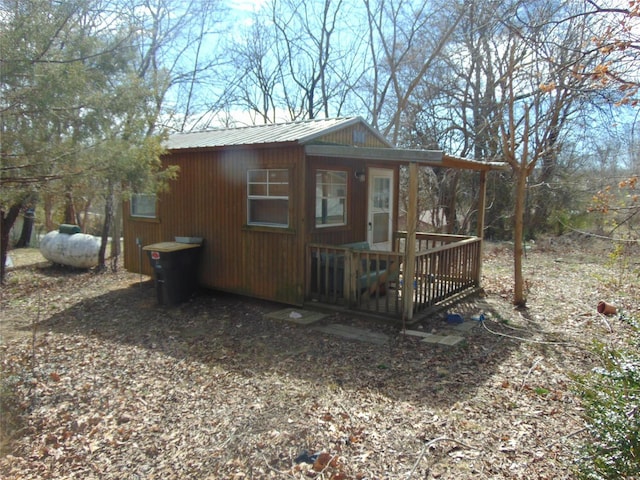 view of side of property with an outbuilding and metal roof