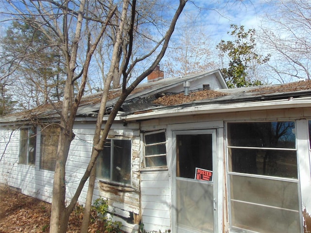 view of side of home with a chimney