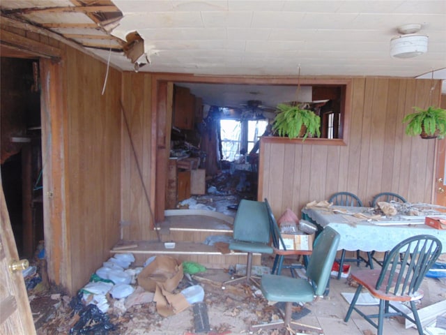 dining room with wood walls