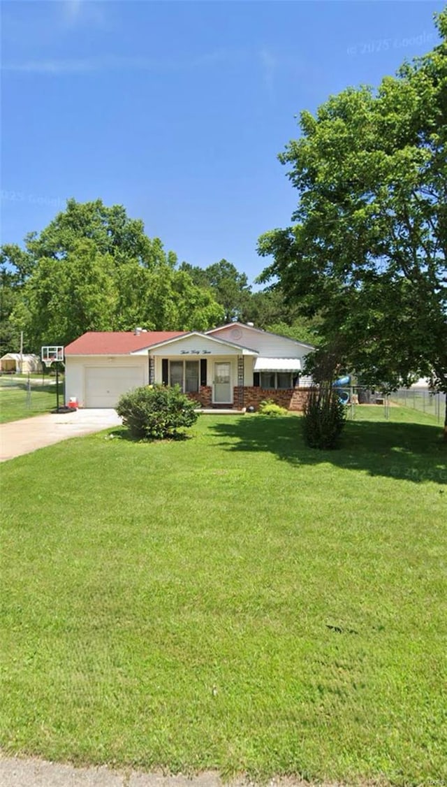 ranch-style house with driveway, a garage, and a front yard