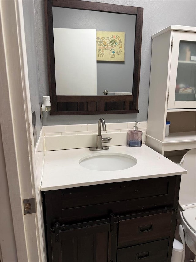 half bath featuring toilet and vanity