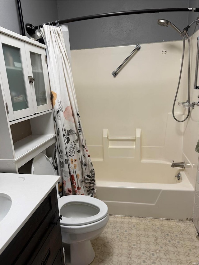 full bath with toilet, tile patterned floors, shower / bath combo with shower curtain, and vanity