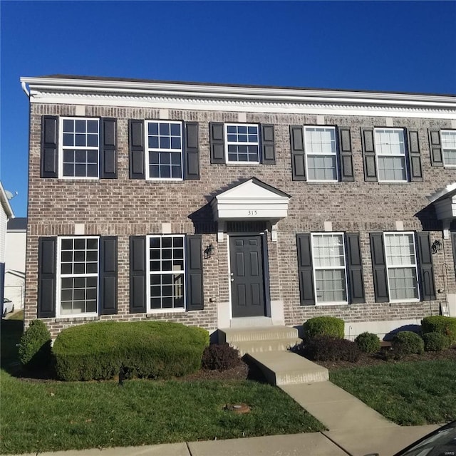 view of front of home featuring brick siding