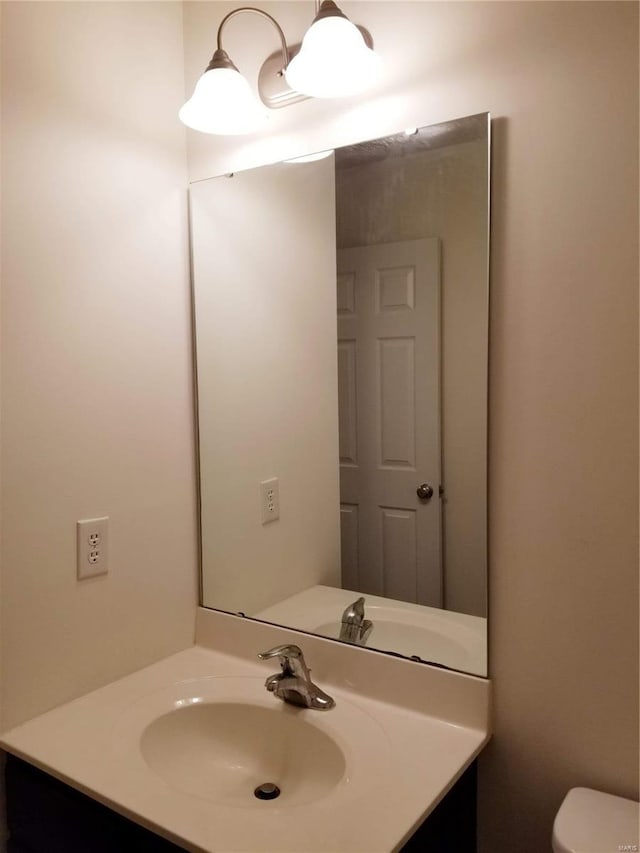 half bath with vanity and toilet