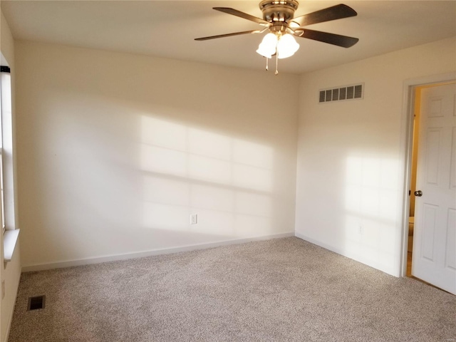 unfurnished room featuring a ceiling fan, baseboards, visible vents, and carpet flooring