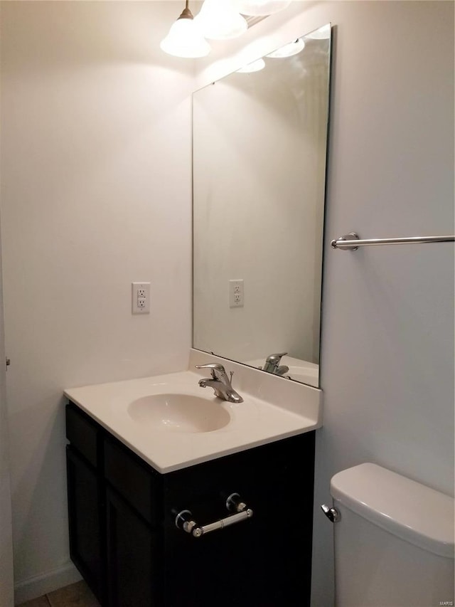 bathroom featuring toilet and vanity