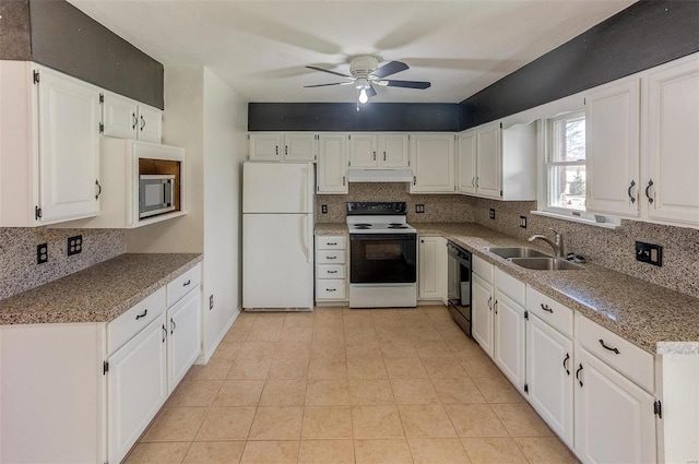 kitchen featuring electric range, dishwasher, freestanding refrigerator, under cabinet range hood, and a sink