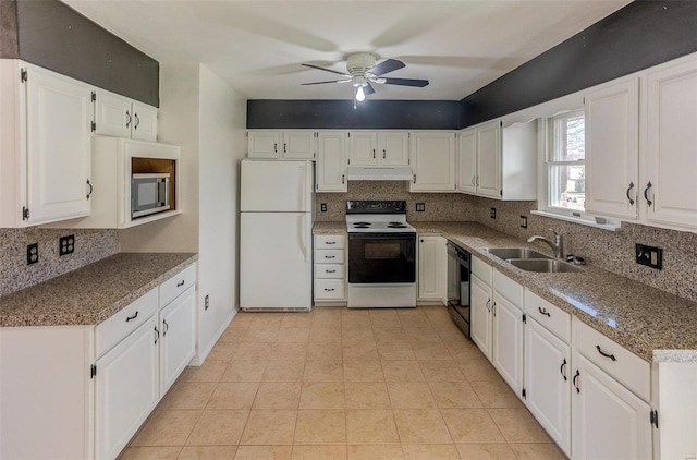 kitchen with range with electric cooktop, freestanding refrigerator, under cabinet range hood, white cabinetry, and a sink