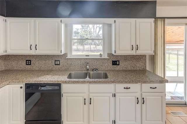 kitchen with dishwasher, tasteful backsplash, a sink, and white cabinets