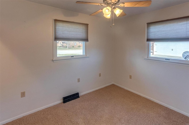 spare room with baseboards, carpet flooring, and a healthy amount of sunlight