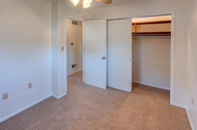 unfurnished bedroom featuring a closet, visible vents, and carpet flooring