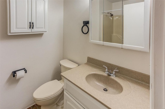 bathroom with toilet, a shower, and vanity