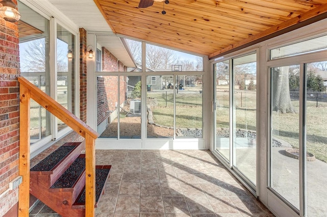 unfurnished sunroom with lofted ceiling and wooden ceiling