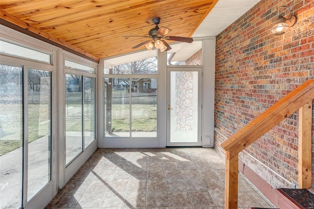 unfurnished sunroom featuring lofted ceiling, wooden ceiling, and ceiling fan