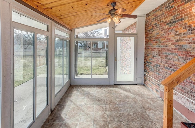 unfurnished sunroom featuring lofted ceiling, wooden ceiling, and ceiling fan