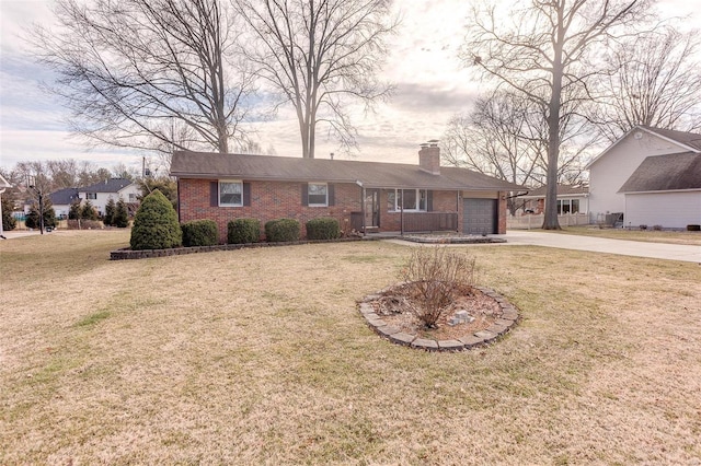 single story home with driveway, a front yard, and brick siding