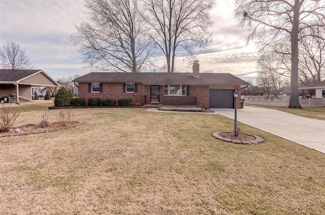 view of front of house featuring a garage, concrete driveway, brick siding, and a front yard