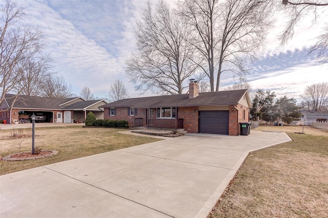 single story home featuring a garage, brick siding, concrete driveway, a chimney, and a front yard