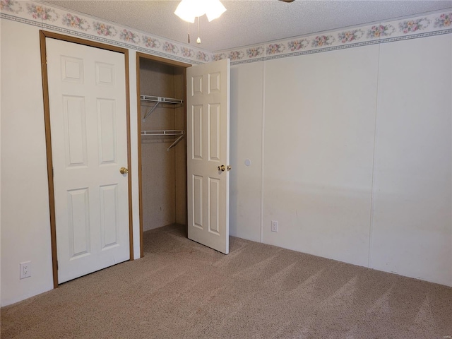 unfurnished bedroom with carpet flooring and a textured ceiling