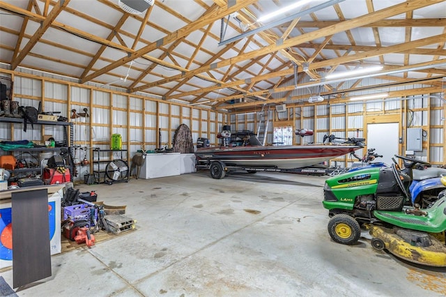 garage with electric panel, metal wall, and a garage door opener