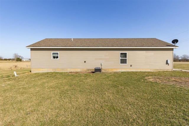 view of property exterior featuring a yard and central AC