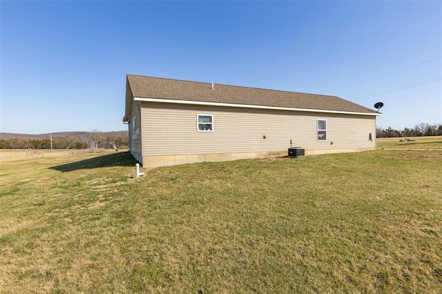 view of home's exterior with a lawn and cooling unit