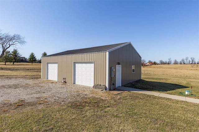 detached garage with a rural view