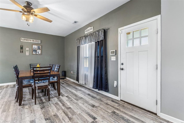 dining room with visible vents, baseboards, wood finished floors, and a ceiling fan