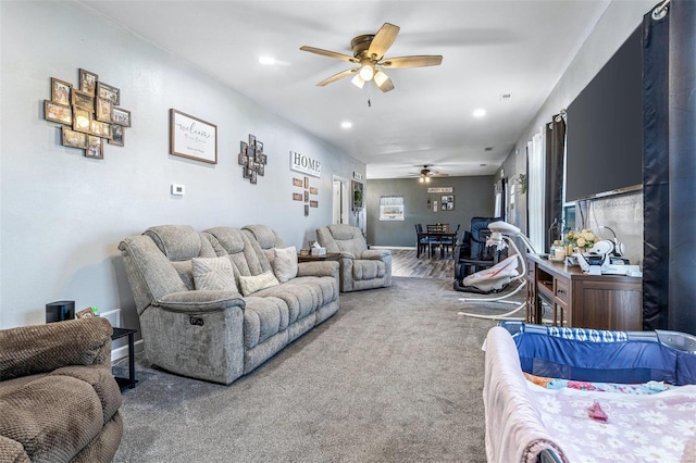 living area featuring carpet flooring, recessed lighting, and a ceiling fan