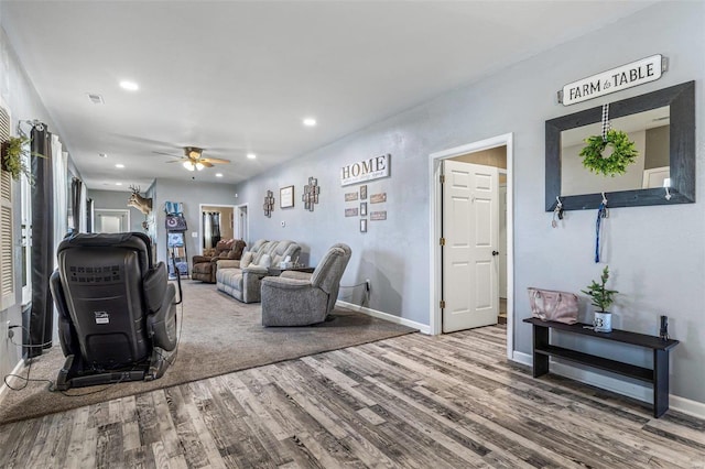 living area with wood finished floors, recessed lighting, a ceiling fan, and baseboards