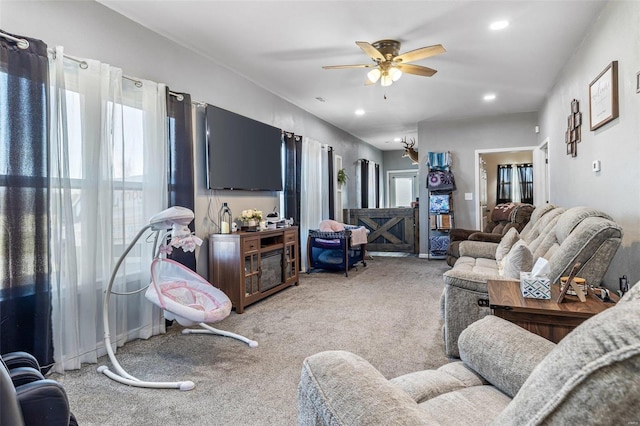 living area with recessed lighting, light colored carpet, and ceiling fan