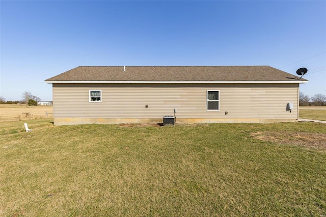 view of home's exterior with central AC unit and a lawn