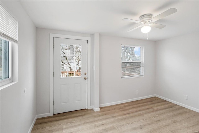 doorway to outside with a ceiling fan, baseboards, and light wood finished floors