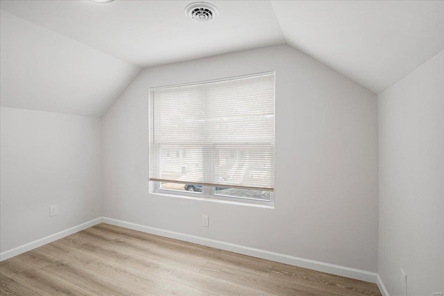 bonus room with visible vents, vaulted ceiling, baseboards, and wood finished floors