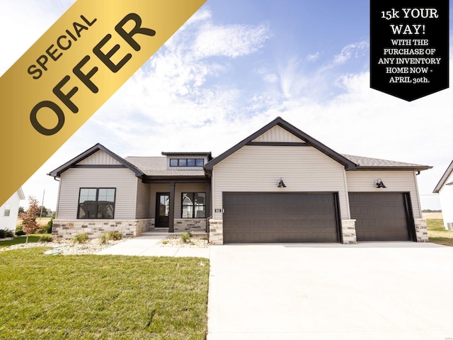 view of front of home with an attached garage, stone siding, driveway, and a front lawn