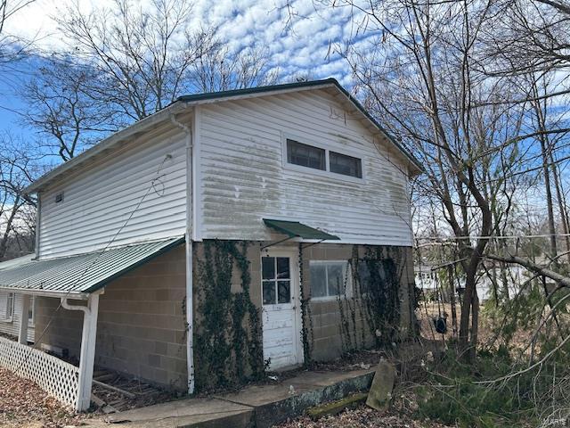 view of property exterior with metal roof