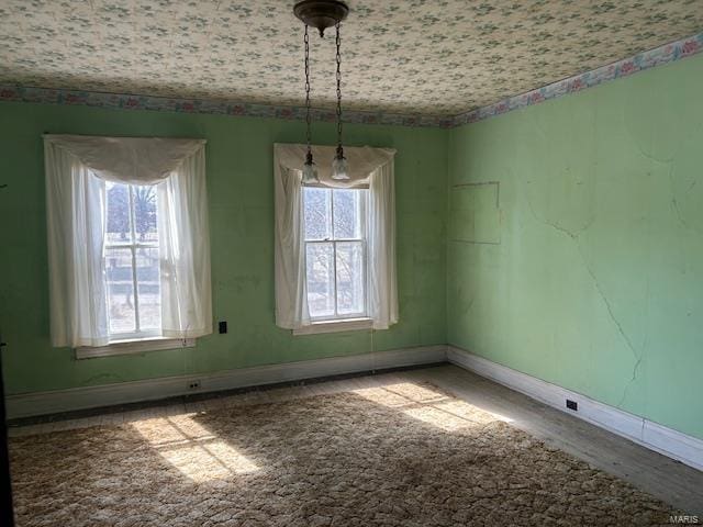 unfurnished room featuring baseboards