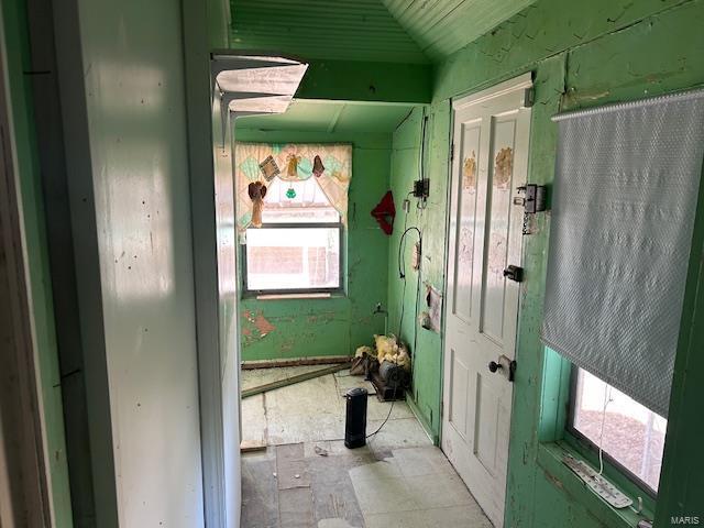 hallway with lofted ceiling